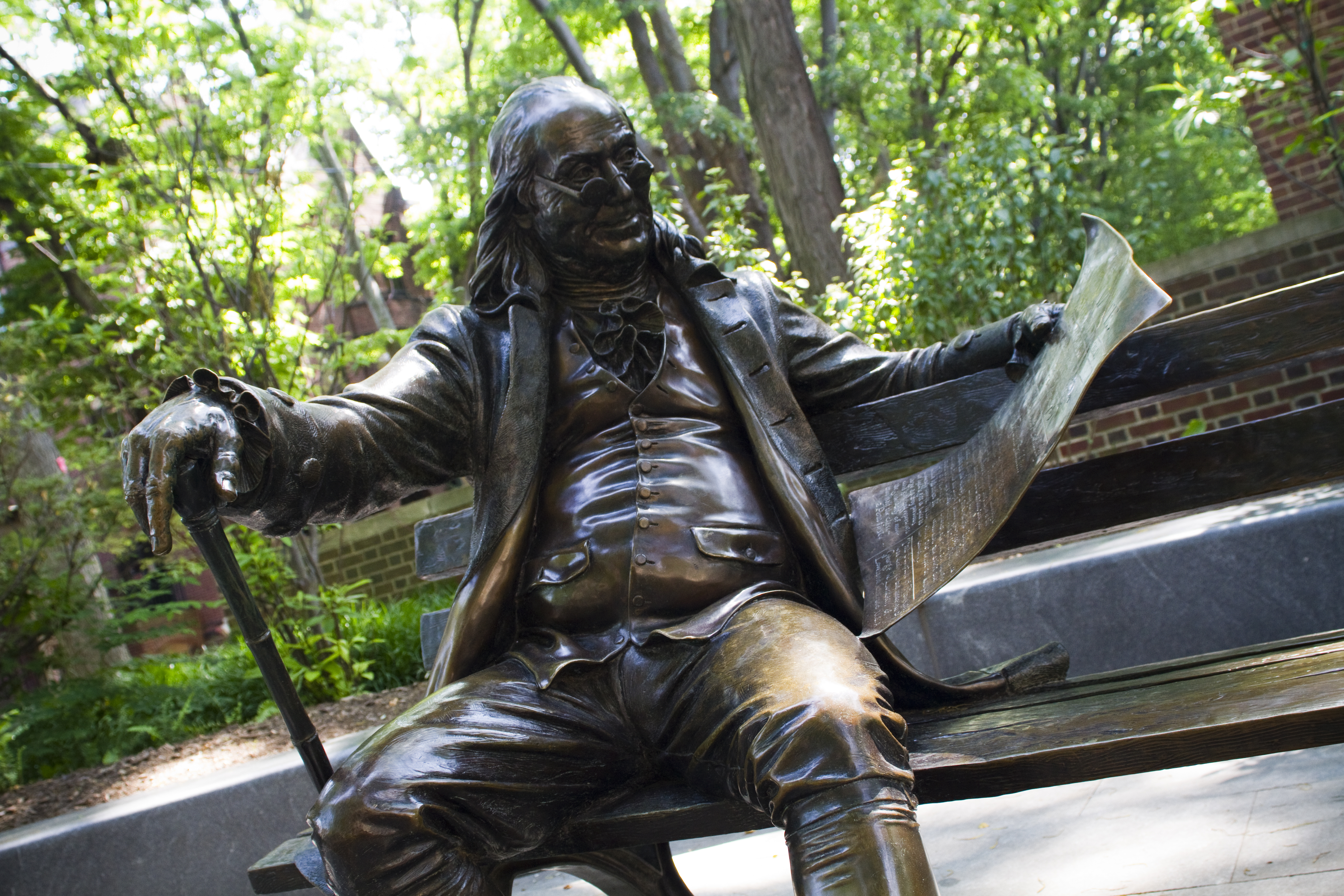ben franklin on a bench statue on penn campus