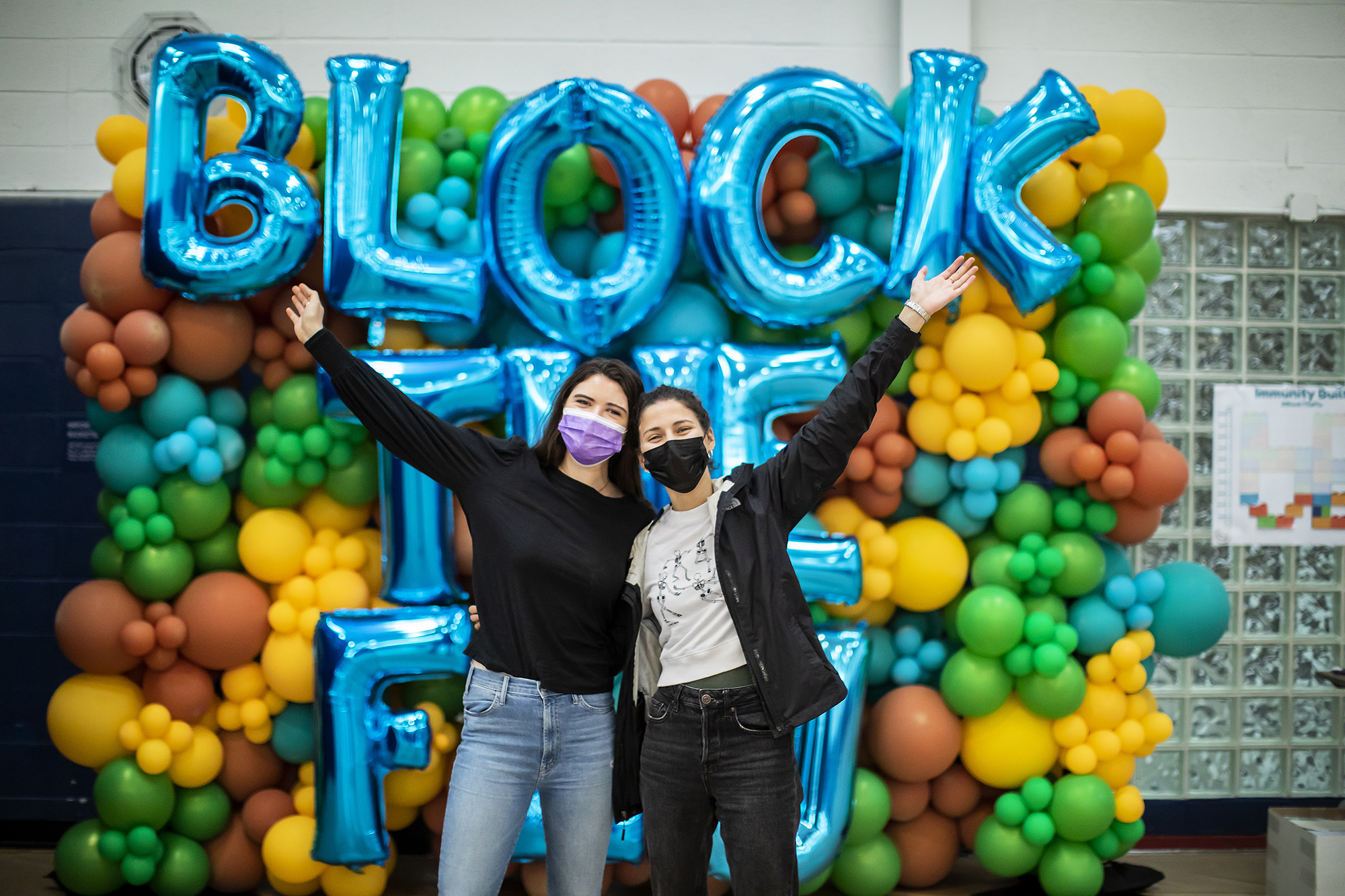 2021 block the flu balloon arch with people posing