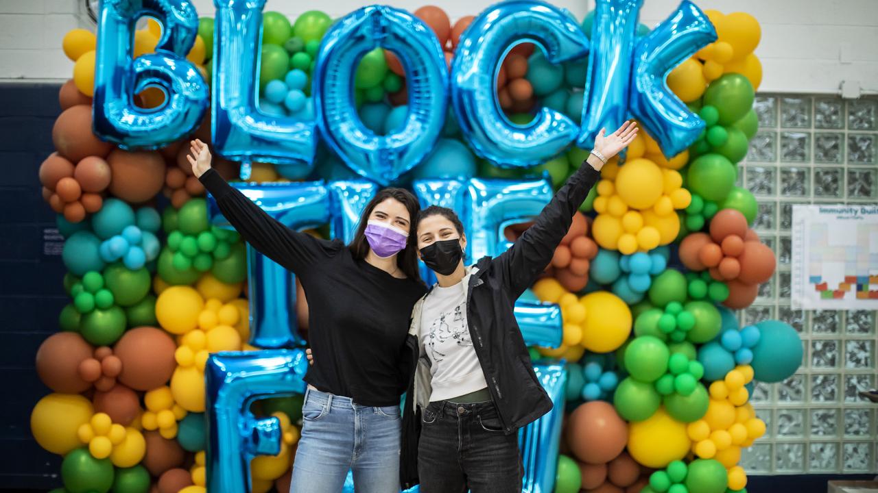 2021 block the flu balloon arch with people posing